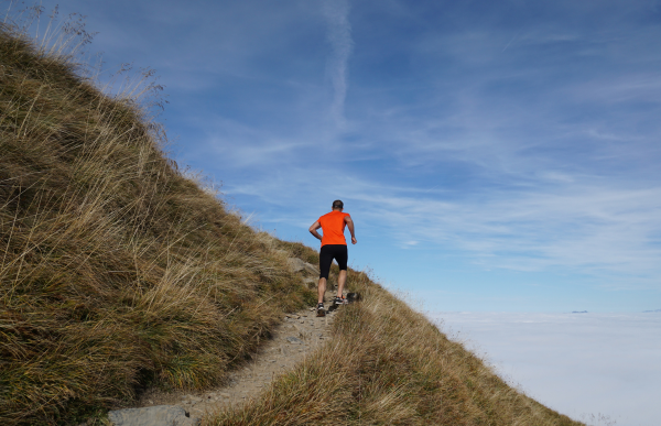 Person running on the hill wearing high visiblity shirt