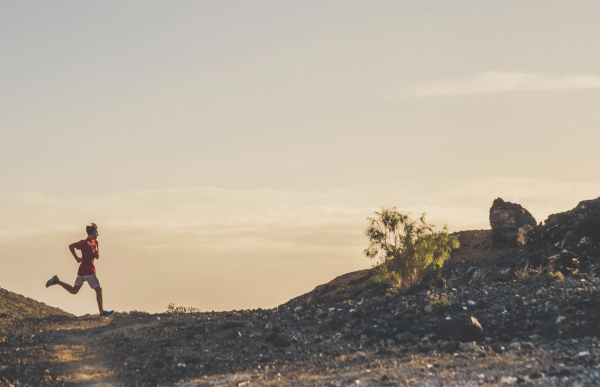 A person Running on a trail in the sunrise